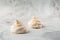 French meringue cookies, macro shot on bright marble background. Tray of meringues. Closeup meringue photo. Dessert