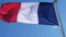 The French national flag waving in the wind.