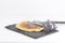 French omelette and fork on black slate plate with decoration heather branch