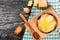 French onion gratin soup in a clay pot, authentic recipe, wooden spoon on a cutting board on an old rustic table, close-up