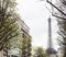 french paris street with Eiffel Tower in perspective trought trees, post card view