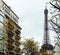 french paris street with Eiffel Tower in perspective trought trees, post card view close up