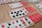 French playing cards stacked together in a solitaire. Solitaire game with cards, pastime with signs and cards with red backs and