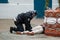 French policeman handcuffing a young man on the floor during riot of high school students on the sidelines of the movement of yell