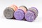 French purple, grey and pink macarons or macaroons, aligned in closeup side view.