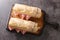 French Sandwich Jambon-Beurre made from a baguette with butter and ham closeup. Horizontal top view
