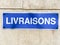 French sign livraisons means deliveries on stone wall