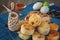 French small rolls in a glass dish with honey in a bowl of colored eggs and Easter knitted Bunny.