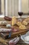 French Snacks with wine - various types of cheeses, bread , dry saussages, charcuterie, red vine on a gray background