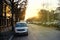 French street at sunset with cars and flare