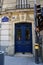 French street with vintage blue door of baroque building decorated with whimsical fretwork. Elegant architecture of Paris France.