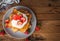 French toast with fresh strawberries, coconut shreds and honey, on wooden background, top view, text space, copy space