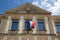 French tricolor and europa flag on france facade mairie text building means city hall in town center