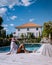 French vacation home with wooden deck and swimming pool in the Ardeche France. woman relaxing by the pool with wooden