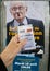 French voter registration card held in front of Jacques Cheminad