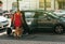 French woman with dogs entering car