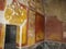Fresco in Bright Colors of Gold Red Black in Ruins of Pompeii It