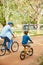 Fresh air and exercise with the boys. Shot of a father and his young son riding bicycles through a park.