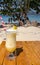 Fresh alcohol cocktail on the beach. Cold pina colada on seascape background. Cool pineapple cocktail with stick. Exotic resort.