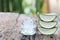 Fresh aloe vera and jelly in Glass bottle placed on a wooden flo