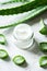 Fresh Aloe Vera Leaves and Natural Cream on a Bright White Surface