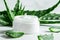 Fresh Aloe Vera Leaves and Natural Cream on a Bright White Surface