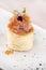 Fresh appetizer with smoked salmon and caviar,  on pastry,  decorated with eatable purple  flower and green leaf,  placed on white