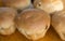 Fresh appetizing buns with toasted crust on a wooden surface. Homemade baking. Selective focus,