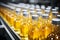 Fresh apple and pineapple juice being filled into glass bottles on the production line