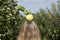 Fresh apple on top of blonde woman\'s head