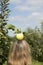 Fresh apple on top of blonde woman\'s head