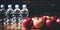 Fresh apples and clear bottles with drinking water on the wooden floor of the gym. A fitness symbol. Generated by And