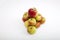 Fresh apples forming pyramid over white background