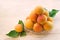 Fresh apricot. Ripe apricots with leaves on a glass plate. Wooden background. Copy space