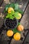 fresh apricots, black currant in a glass bowl transparent scattered on the old wooden tabletop