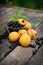 fresh apricots, black currant in a glass bowl transparent scattered on the old wooden tabletop