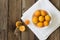 Fresh apricots in a bowl on a wooden background on a kitchen towel. Copy space