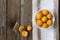 Fresh apricots in a bowl on a wooden background on a kitchen towel. Copy space