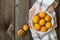 Fresh apricots in a bowl on a wooden background on a kitchen towel. Copy space