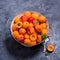 Fresh apricots in colander on dark background, summer fruits