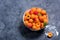 Fresh apricots in colander on dark copy space background, summer fruits