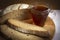 Fresh aromatic rye bread close-up. Slices of bread and a glass of strong tea. The sliced bread lies on a cutting board