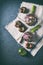 Fresh artichokes, green and black tomatoes on linen textile. Flat lay