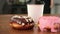 Fresh artisan donuts, take away coffee, wooden table background, tasty donut