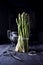 Fresh Asparagus bundle standing upright in rustic setting