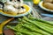 Fresh asparagus lies on a wooden background. Preparing for green grilling