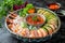 Fresh Assorted Sushi Platter with Salmon, Tuna, Prawns, Avocado, and Spicy Sauce on Dark Background