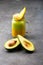 Fresh avocado and mango smoothie on a gray vintage table