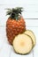 Fresh azores pineapple fruit on a white wooden backgrou