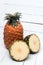 Fresh azores pineapple fruit on a white wooden backgrou